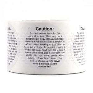 Roll of round candle warning labels reading Caution with burn-safely instructions