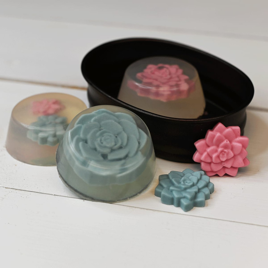 Unmolded succulent embed bars with the colored succulents suspended in translucent soap